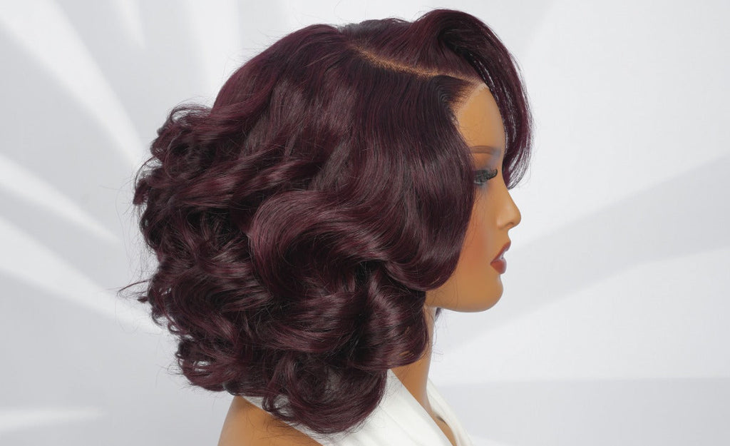 Mannequin head with a burgundy wig on a white background